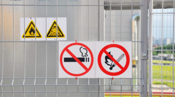 Factory. Sign Flammable on the fence of an industrial facility
