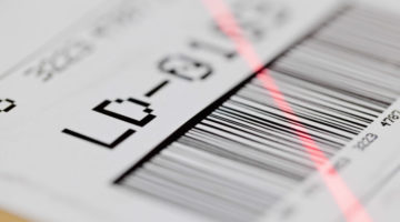Barcode on shipping label on box scanned by automatic laser scanner